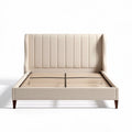Upholstered bed frame with wood slats and neutral beige fabric finish